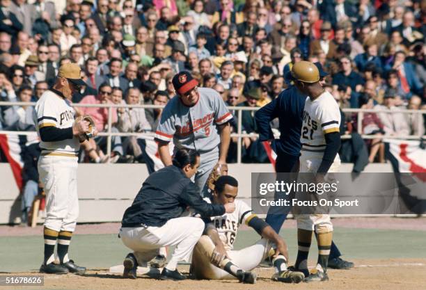 Al Oliver of the Pittsburgh Pirates gets some help from the trainer during the World Series at Three Rivers Stadium on October 1971 in Pittsburgh,...