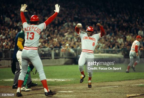 Joe Morgan of the Cincinnati Reds heads for home plate as teammate Dave Concepcion tells him not to slide during the World Series against the Oakland...
