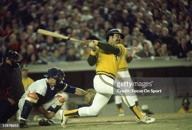 Reggie Jackson of the Oakland Athletics swats the ball during the World Series against the New York Mets at Shea Stadium on October 1973 in Flushing,...