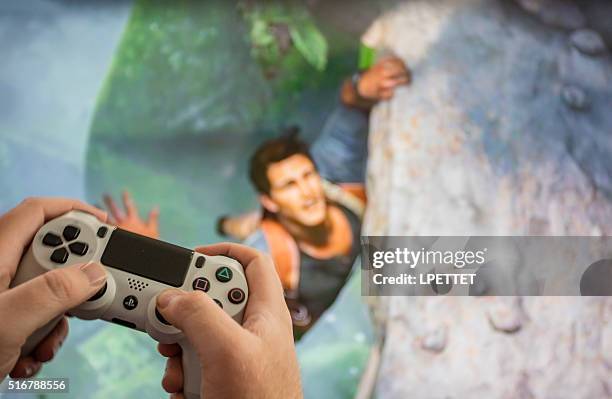 ps4 video game uncharted 4 - ps4 stock pictures, royalty-free photos & images