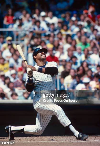 Hall of Famer Reggie Jackson of the New York Yankees watches the ball he batted fly during at Yankee Stadium in Bronx, New York.