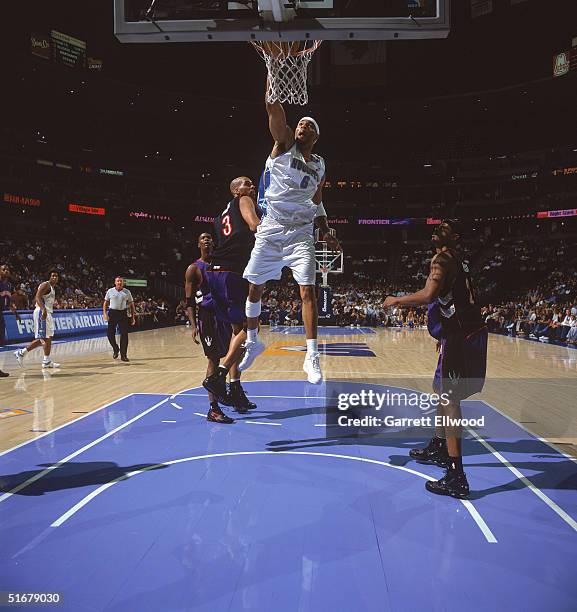 Kenyon Martin of the Denver Nuggets reaches for the basket against Loren Woods of the Toronto Raptors during the game at Pepsi Center on October 26,...