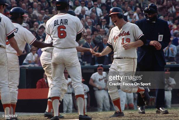Orioles' pitcher Dave McNally is greeted by his team after scoring a home run during game 3 the 1970 World Series against the Cincinnati Reds at...