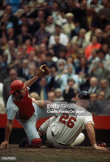 Johnny Bench of the Cincinnati Reds holds the ball after a play at home with Boog Powell of the Baltimore Orioles during the World Series at Memorial...