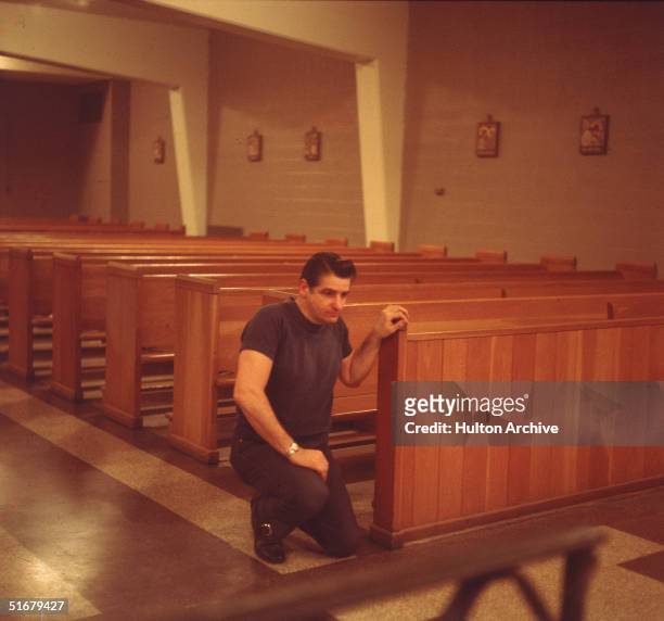 American Albert DeSalvo prays in the chapel at Walpole State Prison, South Walpole, Massachusetts, early 1970s. DeSalvo is the alleged Boston...