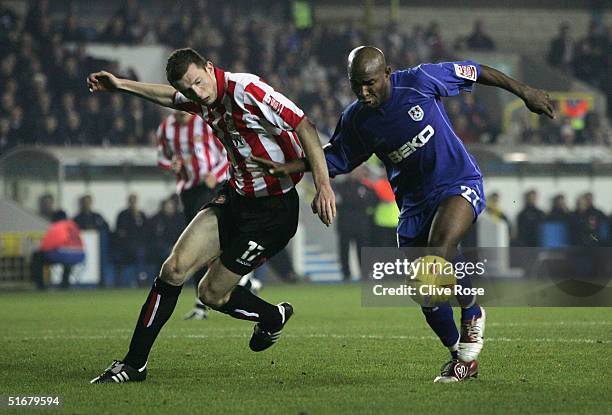 Barry Hayles of Millwall is tackled by Neil Collins of Sunderland during the Coca Cola Championship match between Millwall and Sunderland at The Den...