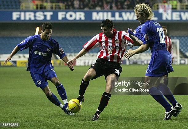 Michael Bridges of Sunderland is tackled by Darren Ward of Millwall during the Coca Cola Championship match between Millwall and Sunderland at The...