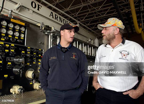 Andrew Guzzo , a rescue worker with the Citizens Volunteer Fire Company of Arnold, Pennsylvania, talks with his father Albert Guzzo , president and...
