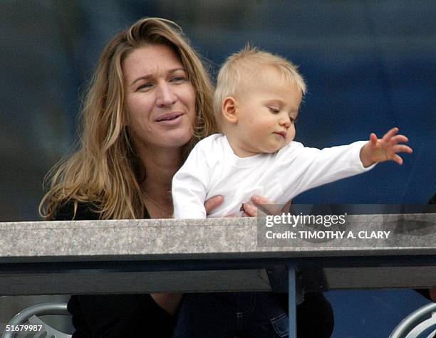 Steffi Graf and her son Jaden Gil watch as Andre Aggasi plays against Ramon Delgado of Paraguay at the 2002 US Open Tennis Tournament 31 August, 2002...