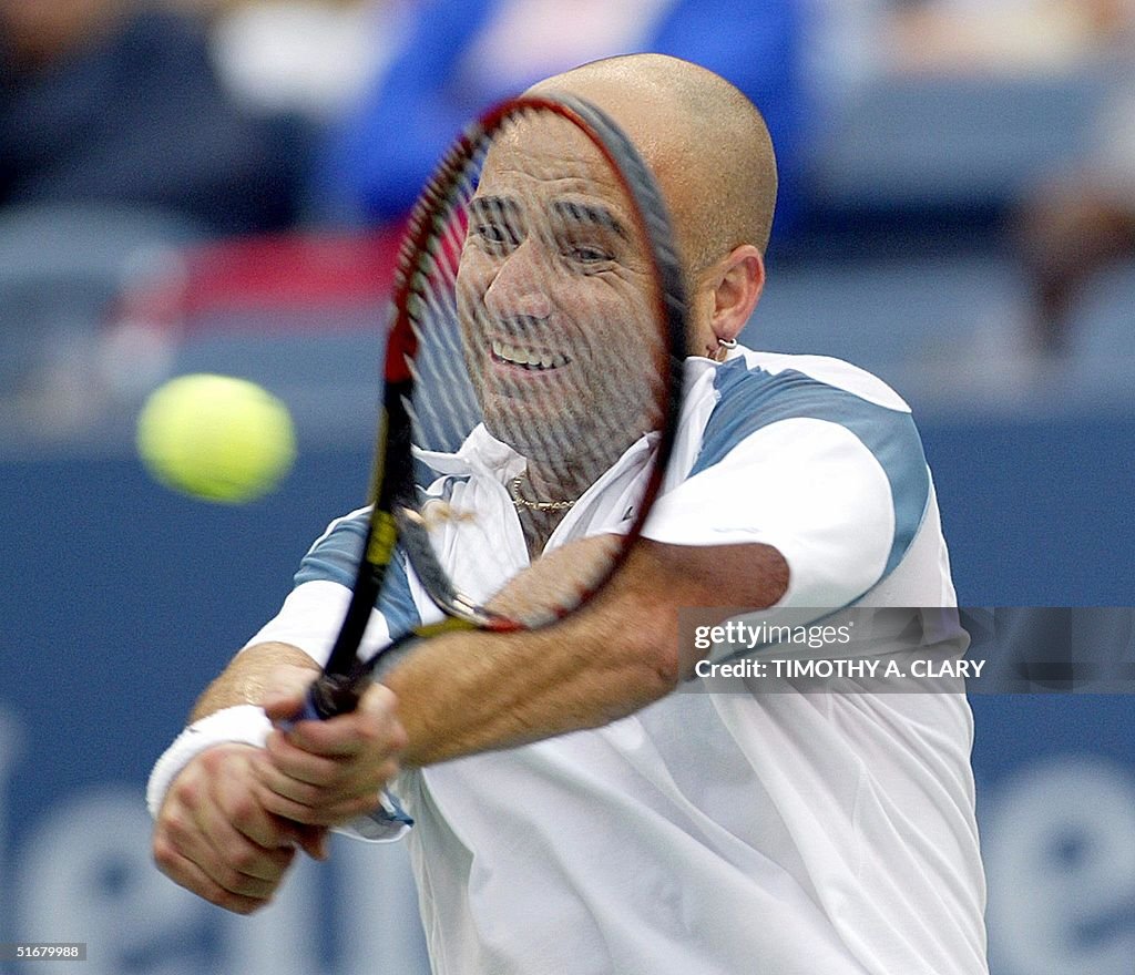 Number six seeded Andre Aggasi of the US backhands