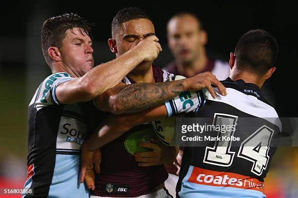 Chad Townsend and Gerard Beale of the Sharks tackle Dylan Walker of the Eagles during the round three NRL match between the Manly Sea Eagles and the...