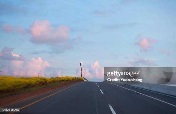 asphalt road to the heaven in sunset,blur shoing the fast motion,good material for auto advertisement - fast motion stock pictures, royalty-free photos & images