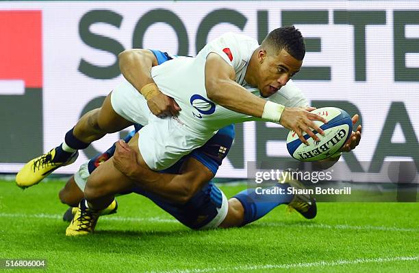 Anthony Watson of England scores his team's third try despite the tackled from Wesley Fofana of France during the RBS Six Nations match between...