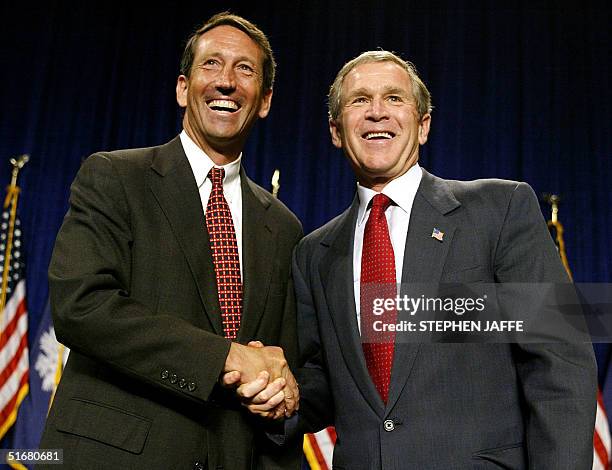 President George W. Bush shakes hands with Mark Sanford at the North Charleston Convention Center 29 July 2002 in Charleston, South Carolina. Bush...