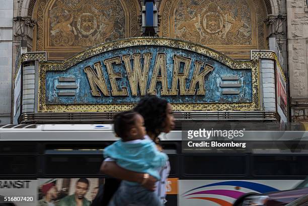 Pedestrian walks in front of the Paramount Theater, which has been closed since 1986, on Market Street in Newark, New Jersey, U.S., on Wednesday,...