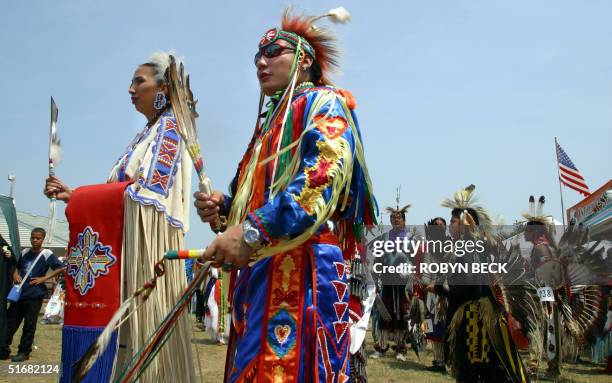 Head Man Delwin Fiddler of the Lakota Sioux tribe and Head Lady Toni Tsatooke of the Kiowa tribe lead dancers into the circle for the "Grand Entry"...