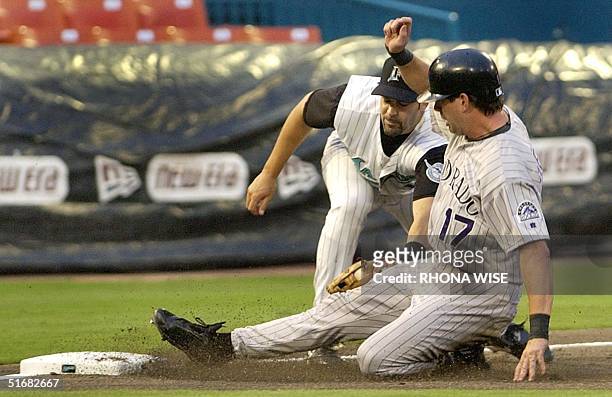 Florida Marlins third baseman Mike Lowell tags out Colorado Rockies' first baseman Todd Helton during the second inning at Pro Player Stadium in...