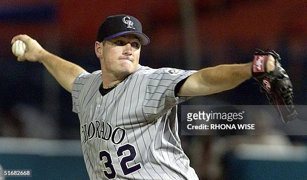 Colorado Rockies' pitcher Jason Jennings delivers a pitch to Florida Marlins' outfielder Preston Wilson During sixth inning action 12 August at Pro...