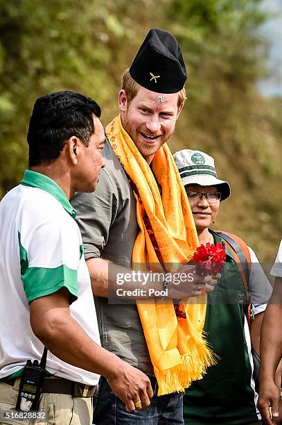 Prince Harry receives a Gurkha hat at Bhir Kuna as the arrives at the earthquake struck village during day three of his visit to Nepal on March 21,...