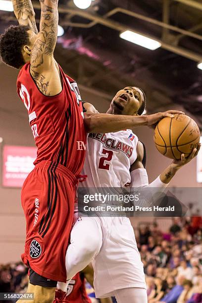 Maine Red Claws guard Corey Walden drives against Raptors 905 forward Michale Kyser .