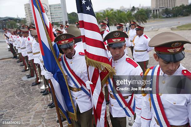 Cuban military color guard carrying a Cuban flag and an American flag wait for the arrival of U.S. President Barack Obama before he attends a wreath...