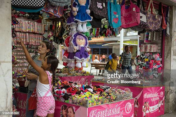 Woman and a girl shop at the Fantasia Virtual store in Medellin, Colombia, on Monday, March 14, 2016. Colombia's central bank raised its benchmark...