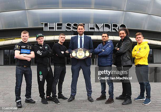 Promoter Eddie Hearn looks on as Charlie Flynn, Willie Limond, Ricky Burns, Michele De Rocco, Tyrone Nurse and Lewis Paulin pose during the Ricky...