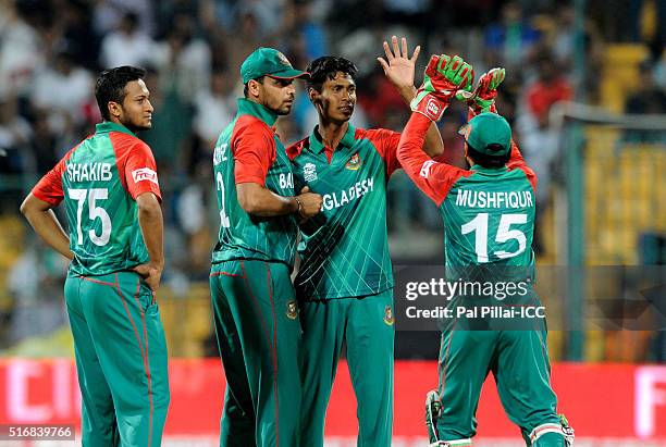 Mustafizur Rahman of Bangladesh celebrates the wicket of Steven Smith, Captain of Australia during the ICC World Twenty20 India 2016 match between...