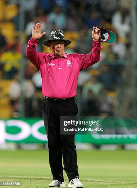 Field umpire Ian Gould signals a six during the ICC World Twenty20 India 2016 match between Australia and Bangladesh at the Chinnaswamy stadium on...