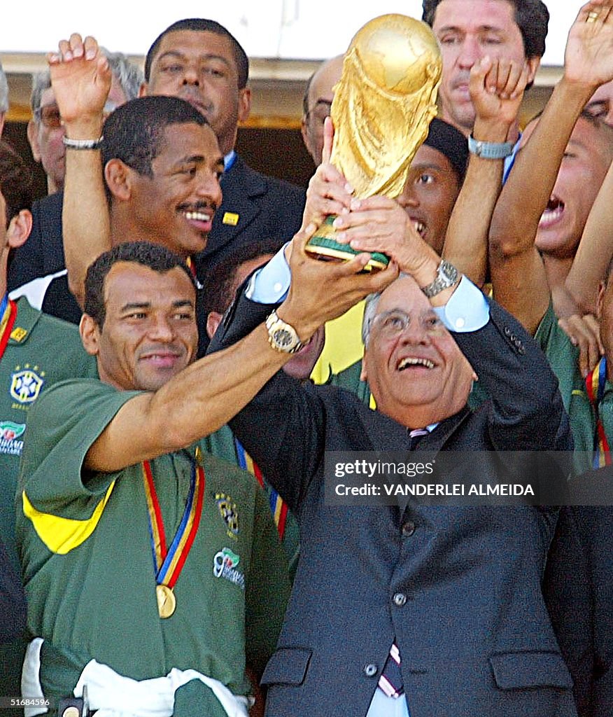 Brazilian soccer team captain Cafu (L) gives the W