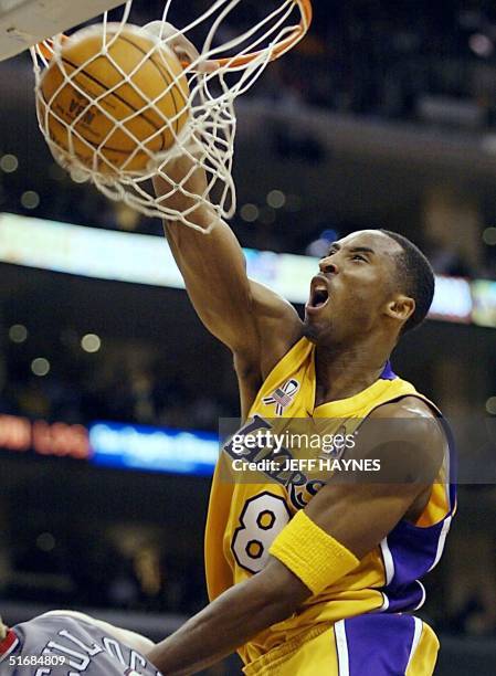 Kobe Bryant of the Los Angeles Lakers dunks the ball against the New Jersey Nets in the 3rd quarter of game one of the NBA Finals against 05 June...