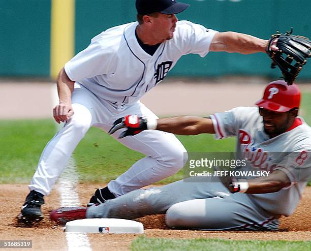 Philadelphia Phillies' Marion Anderson slides safely into third in front of Detroit Tigers' Craig Paquette during the first inning at Comerica Park...