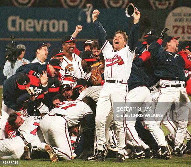Members of the Atlanta Braves celebrate winning their first World Series at Atlanta's Fulton County Stadium 28 October. David Justice's home run won...