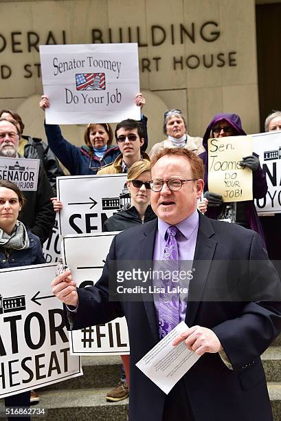 Pennsyslvania Outreach and Engagement Director, Jeff Garis speaks to protesters outside of Senator Pat Toomey's office building during National Day...
