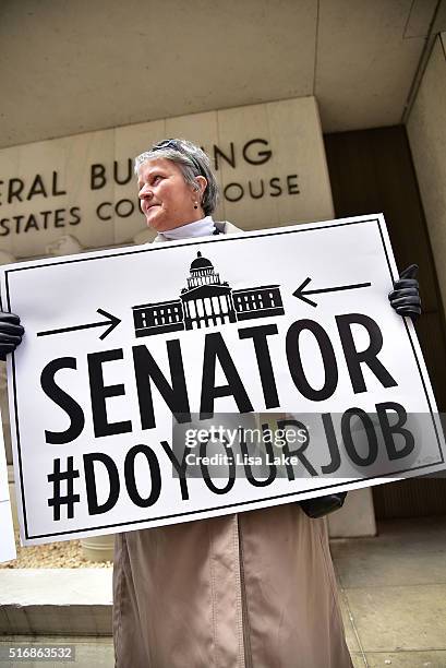 Protester outside of Senator Pat Toomey's office building during National Day Of Action calling on Senate Republicans to "Do Your Job" and uphold...
