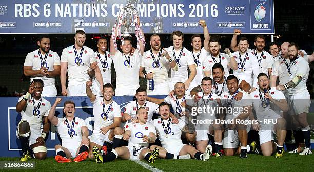 England celebrate as their captain, Dylan Hartley raises the Six Nations Trophy after thier victory during the RBS Six Nations match between France...