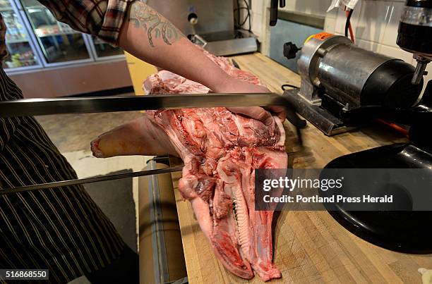 Pete Sueltenfuss butchers as pig at Otherside Delicatessen Monday, March 14, 2016.