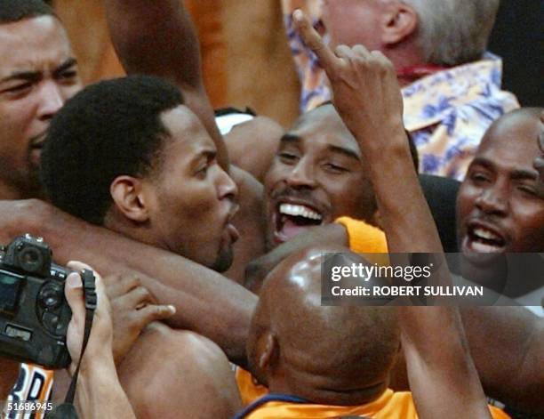 Robert Horry of the Los Angeles Lakers is mobbed by teammates including Kobe Bryant after he made the winning three-point basket to give the Lakers a...