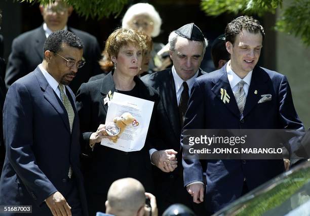 Attorney Billy Martin escorts Dr. Robert Levy , wife Susan and their son Adam after a memorial for their daughter, former Washington intern Chandra...