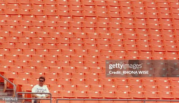 Florida Marlins fan has a section of Miami's Joe Robbie Stadium all to himself as he attends the 27 July doubleheader between the Florida Marlins and...