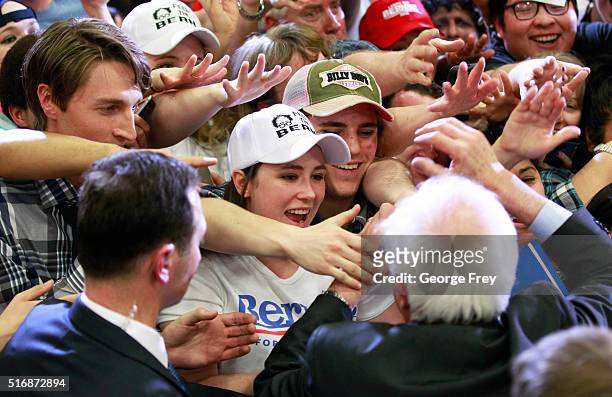 Democratic presidential candidate Bernie Sanders shakes hands with supporters during a campaign rally at West High School on March 21, 2016 in Salt...