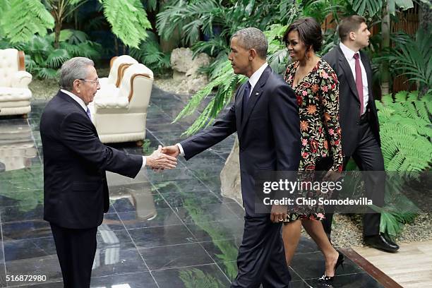 Cuban President Raul Castro greets U.S. President Barack Obama and first lady Michelle Obama before a state dinner at the Palace of the Revolution...