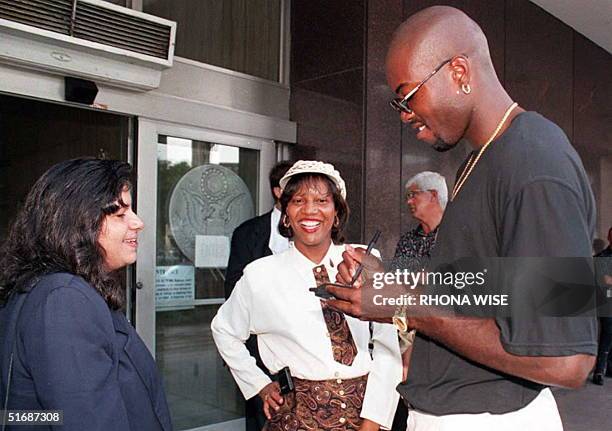 Miami Heat player Glen Rice signs autographs for fans 30 August after he cast his vote at a federal office building in Miami as to whether or not...