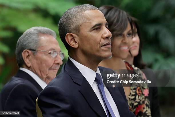 Cuban President Raul Castro , U.S. President Barack Obama and first lady Michelle Obama listen to live music during a state dinner at the Palace of...