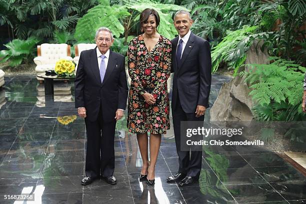 Cuban President Raul Castro poses for a photograph with U.S. First lady Michelle Obama and U.S. President Barack Obama before a state dinner at the...