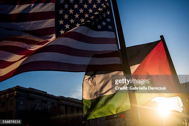 American and Palestinian flags wave outside of the Verizon Center during the American Israel Public Affairs Committee conference on March 21, 2016 in...