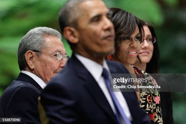 Cuban President Raul Castro , U.S. President Barack Obama and first lady Michelle Obama listen to live music during a state dinner at the Palace of...