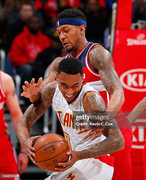Bradley Beal of the Washington Wizards fouls Jeff Teague of the Atlanta Hawks at Philips Arena on March 21, 2016 in Atlanta, Georgia. NOTE TO USER...