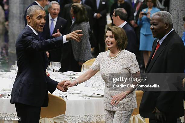 President Barack Obama greets House Minority Leader Nancy Pelosi while acknowledging members of Congress that are attending a state dinner at the...