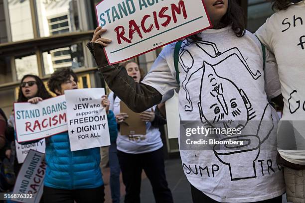 Protesters hold signs and wear homemade shirts outside the American Israeli Public Affairs Committee policy conference in Washington, D.C., U.S., on...